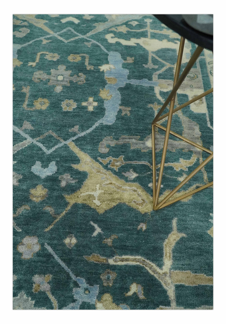 Teal and beige Oushak area rug with ornate geometric pattern, cropped close view.