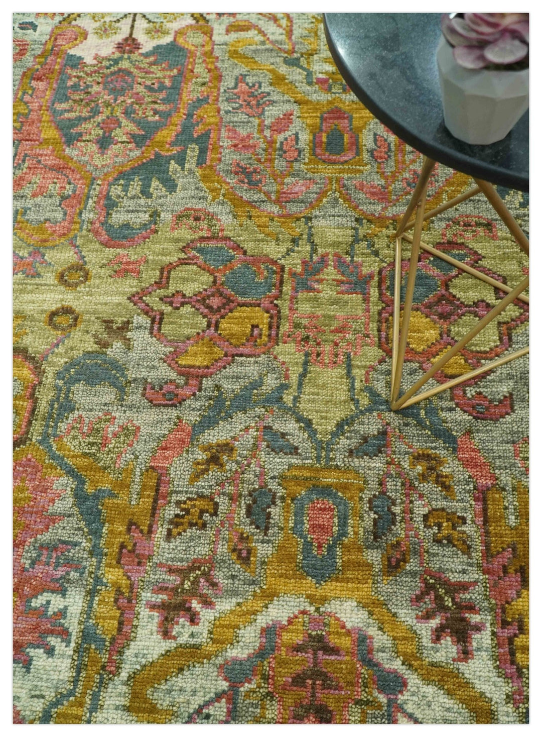 Hand-knotted wool rug close-up with multicolor geometric and vine motifs