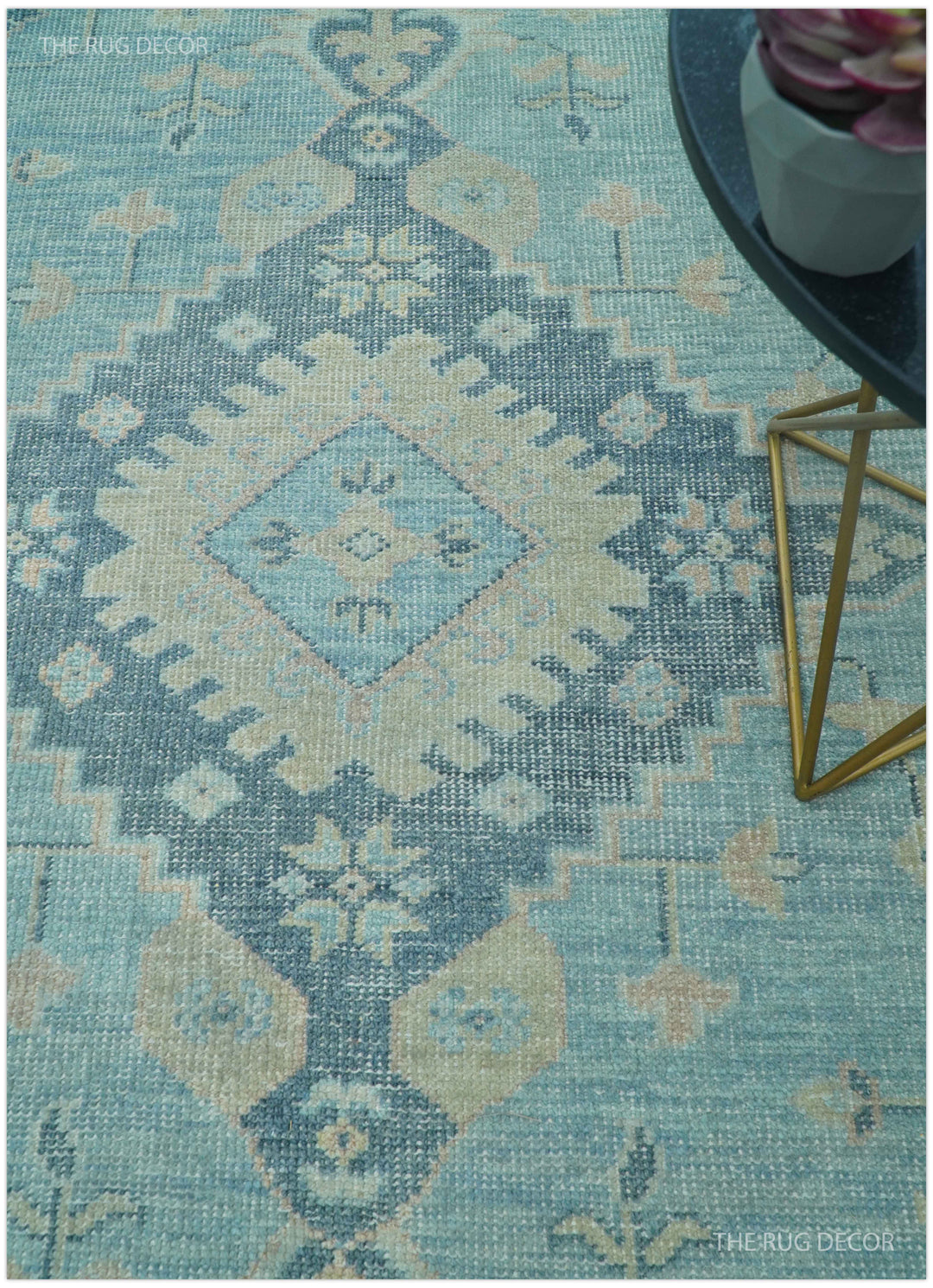 Hand-knotted wool area rug with blue and beige geometric pattern in diagonal view