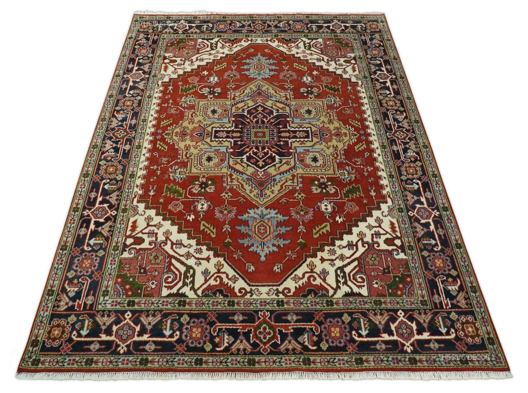 Red and blue Serapi rug with central medallion, geometric motifs, and decorative border