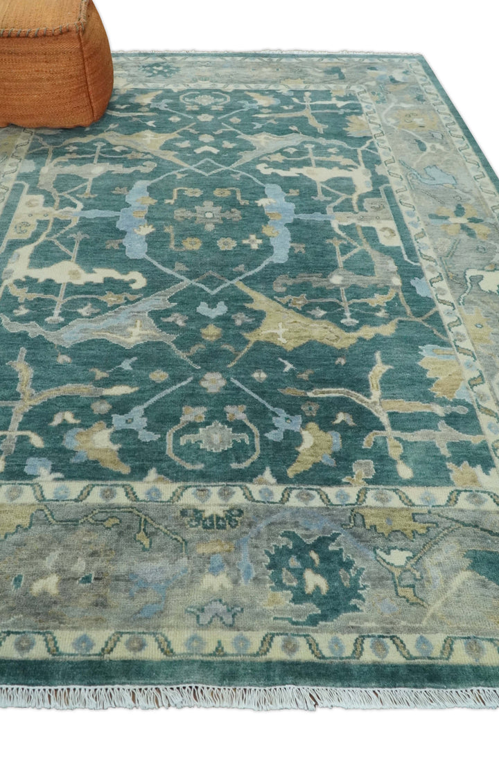 Teal and beige hand-knotted wool Oushak rug with distressed geometric medallion pattern.