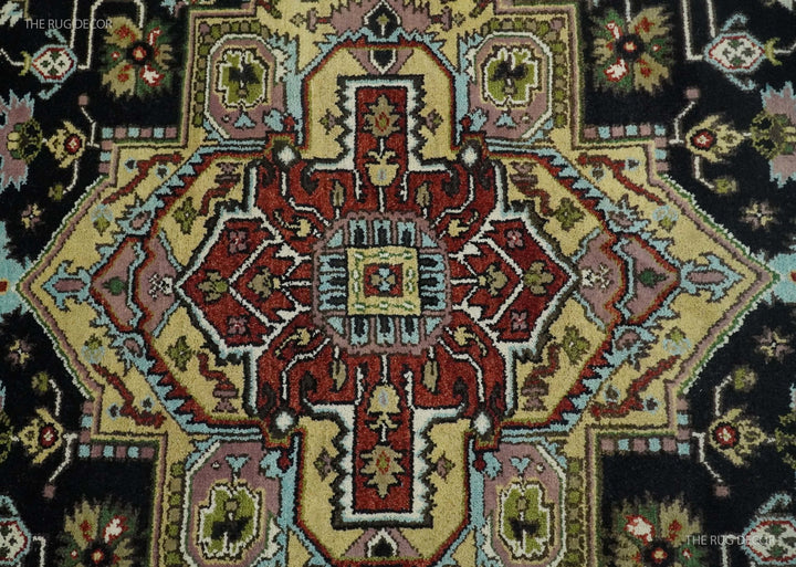 Hand-knotted wool rug center medallion close-up with red, cream, and green accents