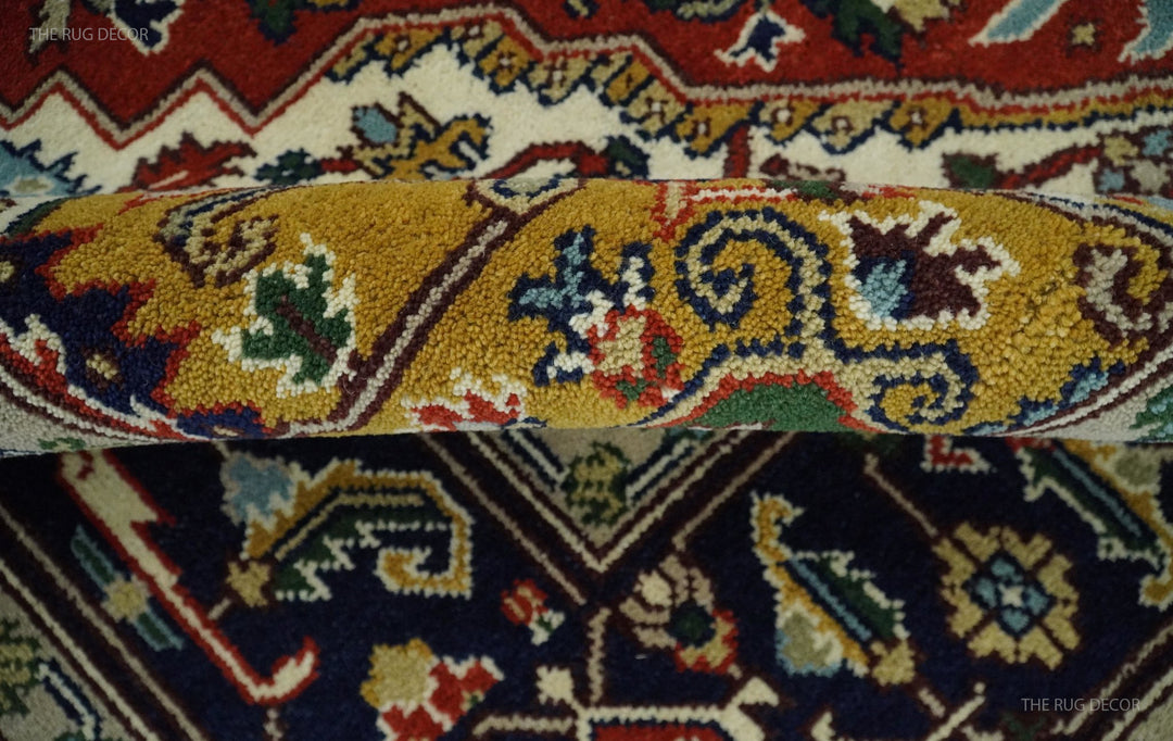 Hand-knotted Heriz-style area rug with yellow medallion and navy floral border