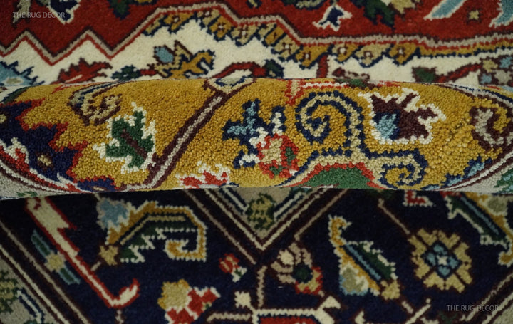 Hand-knotted Heriz-style area rug with yellow medallion and navy floral border