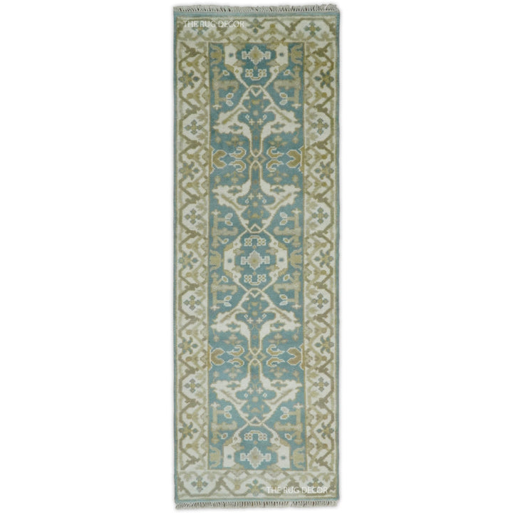 Hand-knotted teal and ivory wool Oushak runner rug with an ornate central pattern
