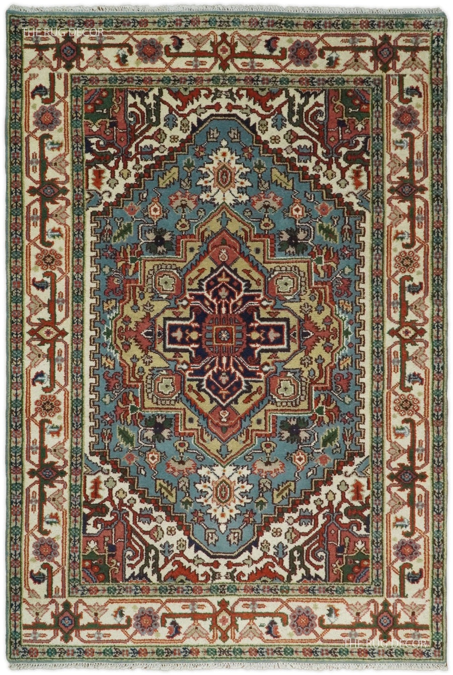 Blue and ivory hand-knotted wool rug with a central medallion and ornate floral border