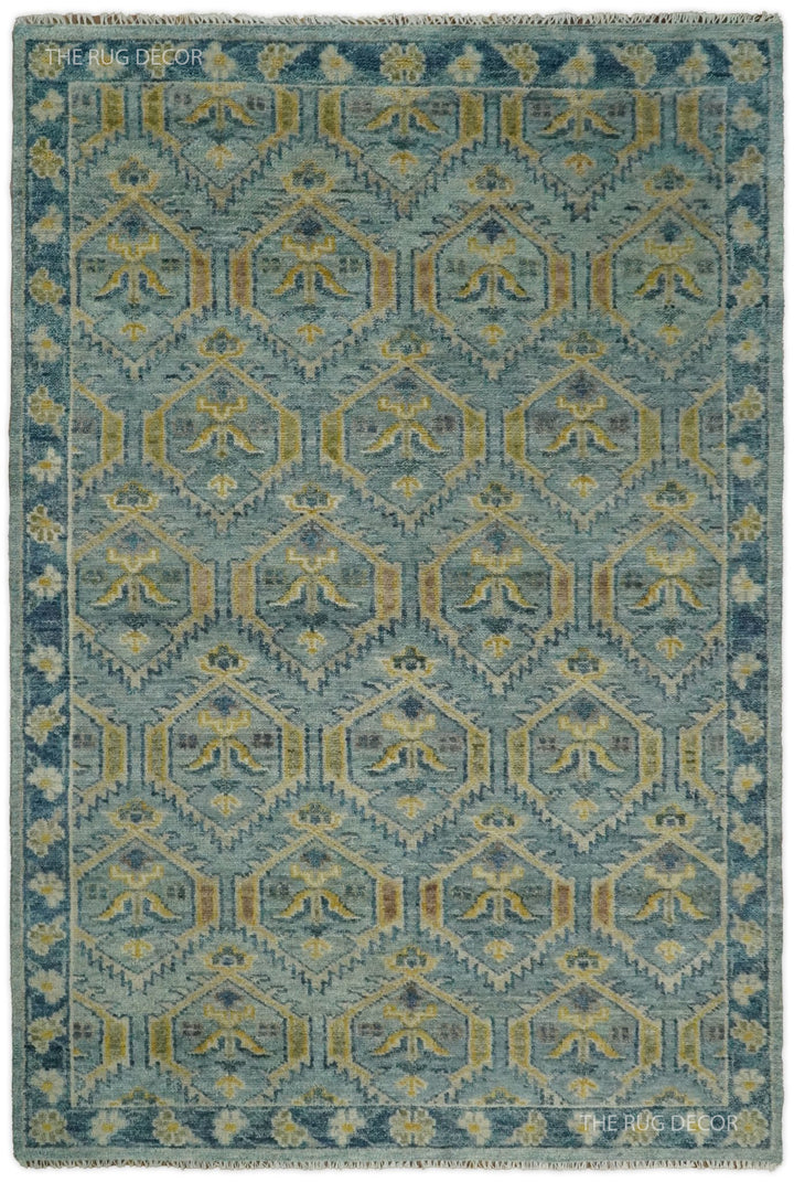 Traditional hand-knotted wool rug in antique blue and mustard with geometric motifs