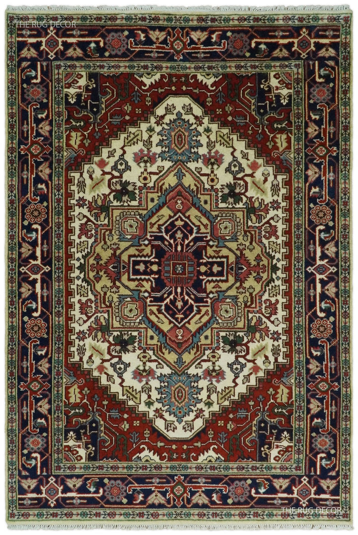 Hand-knotted wool area rug with ivory center medallion, maroon border, and navy accents