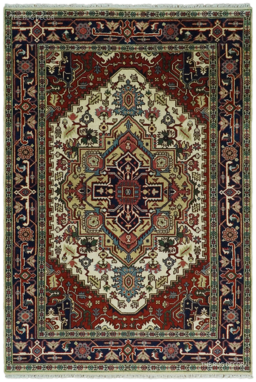 Hand-knotted wool area rug with ivory center medallion, maroon border, and navy accents