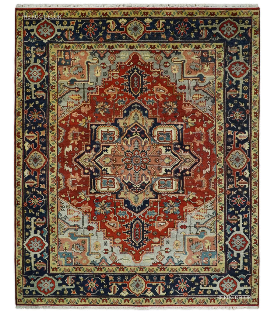Red and blue traditional medallion hand-knotted wool rug with ornate border, cream center