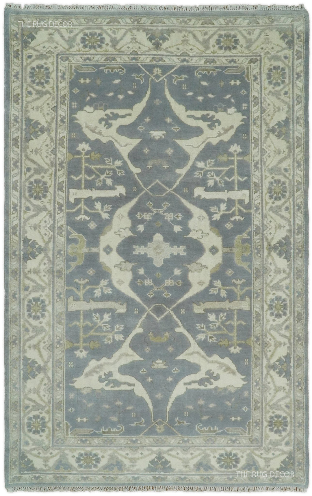Rectangular traditional patterned rug in blue-gray and ivory, ornate border and central motif.