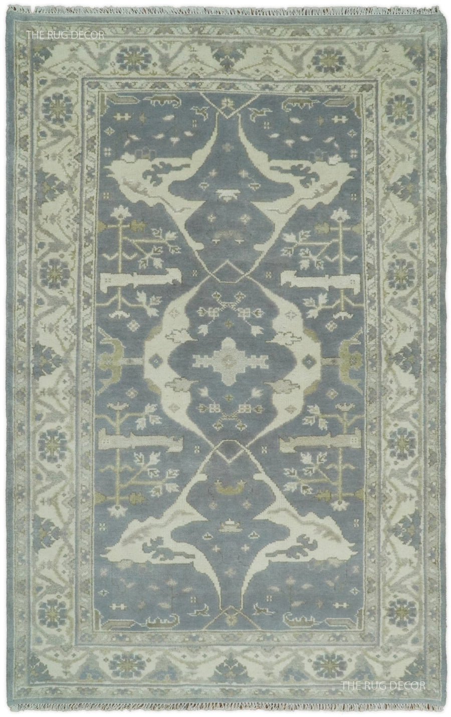 Rectangular traditional patterned rug in blue-gray and ivory, ornate border and central motif.