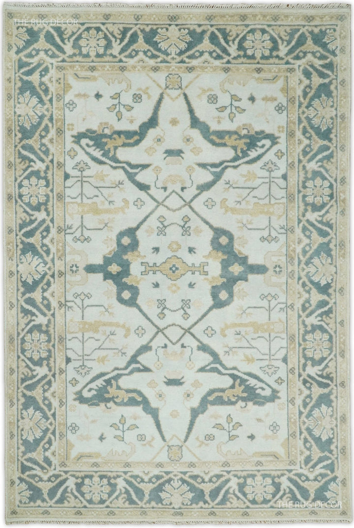 Hand knotted Oushak wool rug with teal and ivory medallion and border