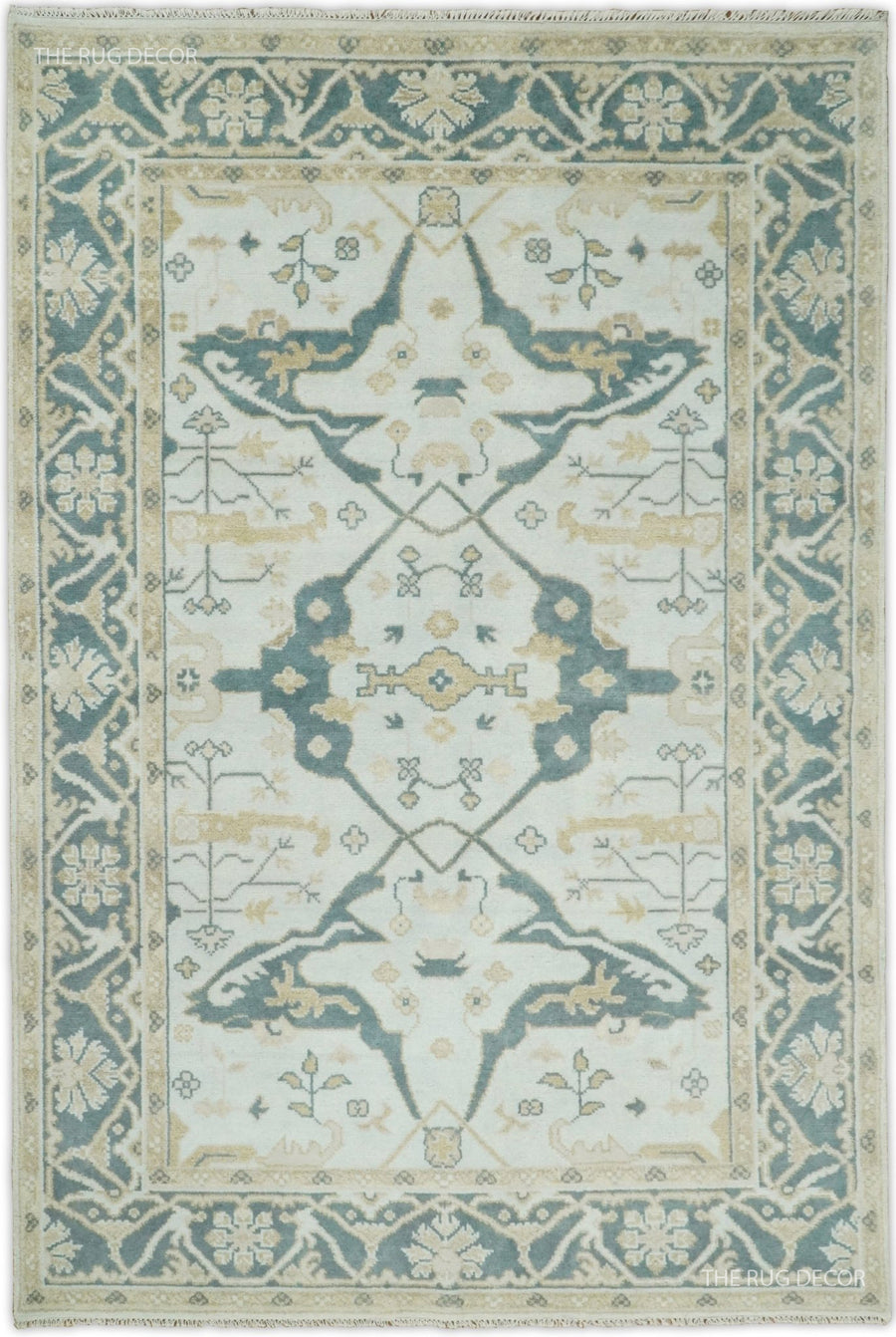 Hand knotted Oushak wool rug with teal and ivory medallion and border