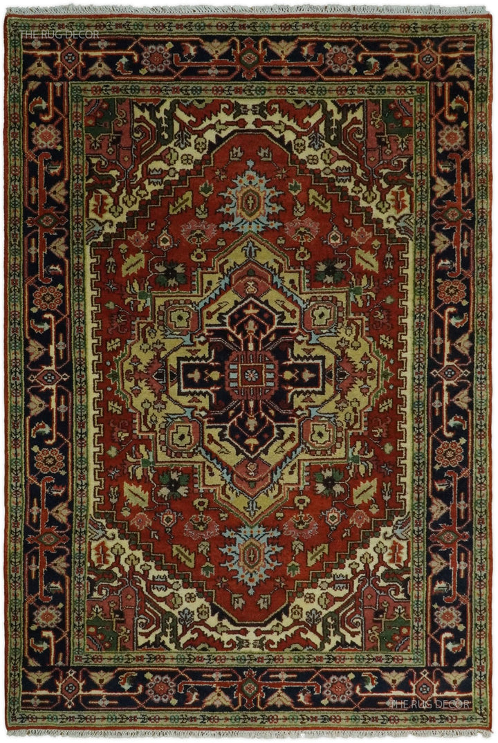Traditional medallion rug with rust red center, dark blue border, and ornate geometric motifs