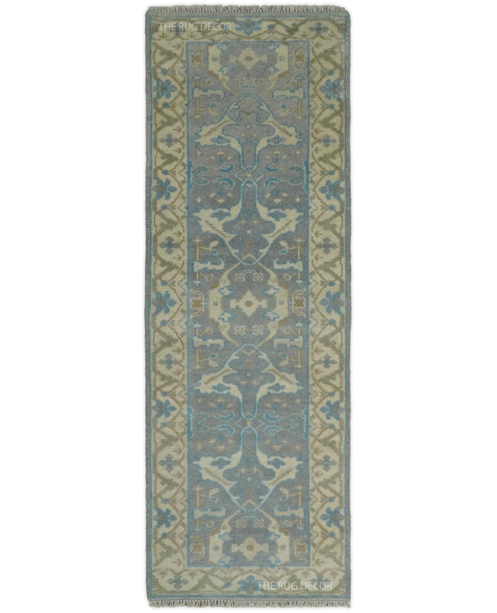 Hand-knotted wool runner rug in gray and beige with blue floral motifs and a patterned border