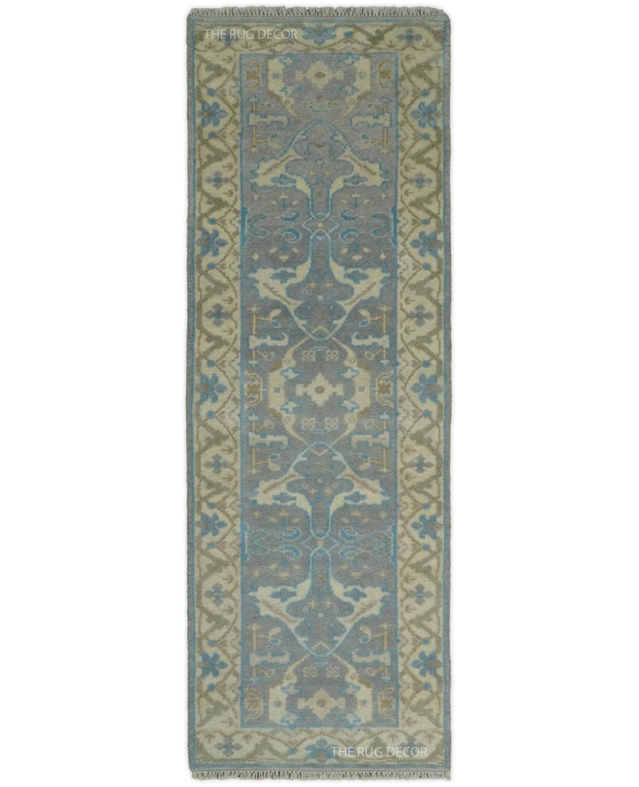 Hand-knotted wool runner rug in gray and beige with blue floral motifs and a patterned border