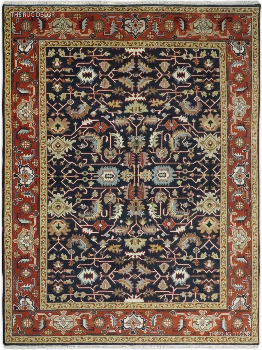 Traditional hand-knotted wool rug with a navy field and red ornamental border