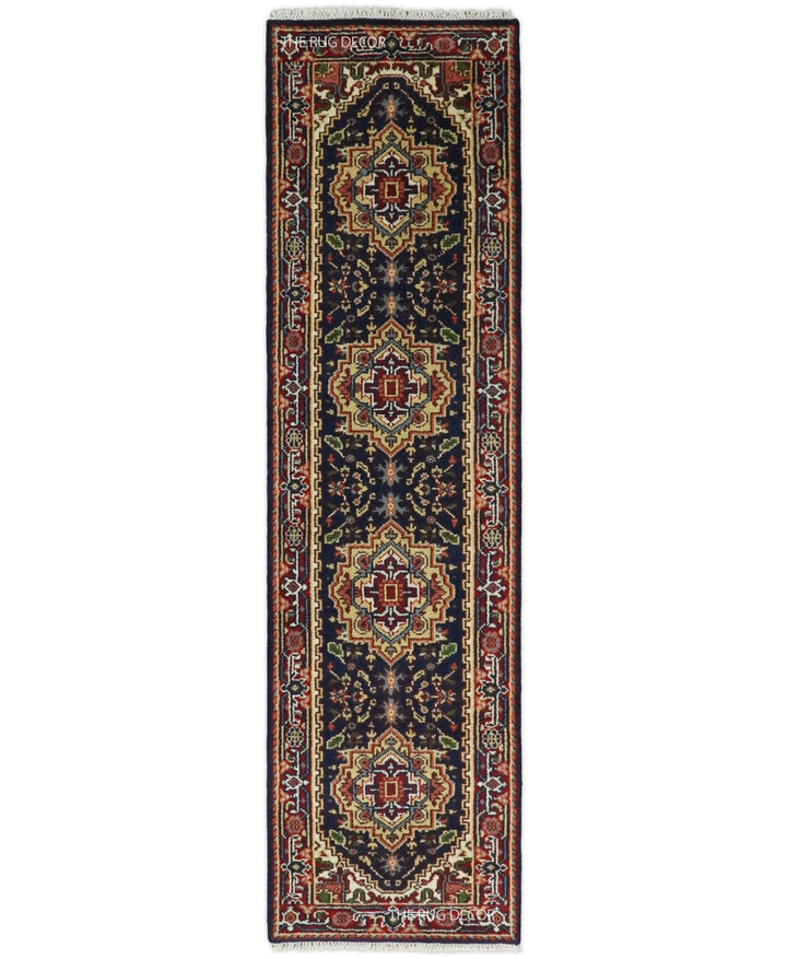 Traditional wool runner rug with red and dark blue geometric motifs and ornate borders