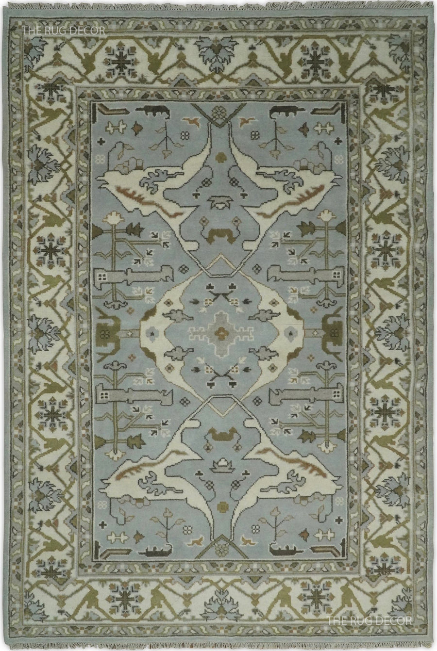 Bluish silver and ivory Oushak rug with a central medallion and ornate floral border