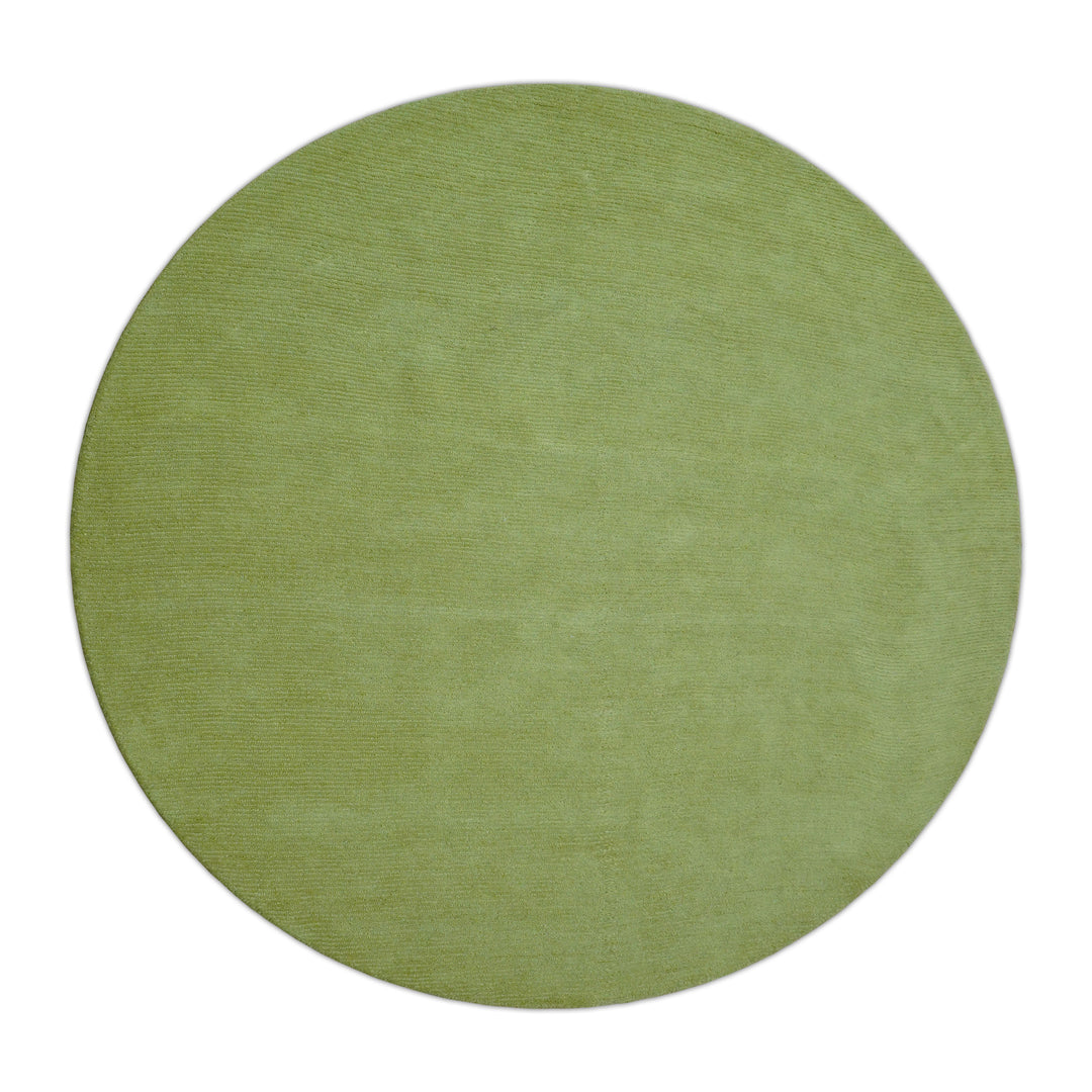Round solid green hand-tufted wool rug, viewed from above