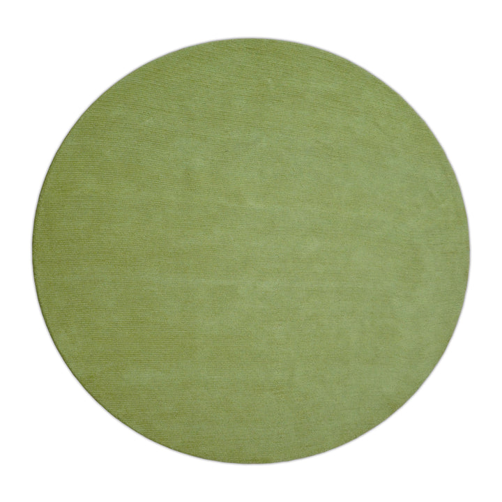 Round solid green hand-tufted wool rug, viewed from above