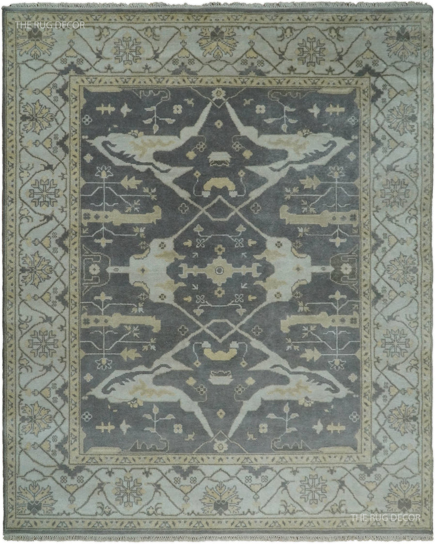 Vintage Oushak-style wool area rug with large gray center medallion in ivory