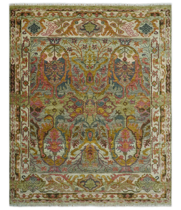 Hand-knotted wool rug with green and gold ornate medallion pattern