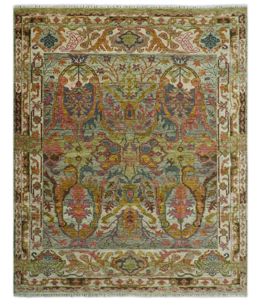 Hand-knotted wool rug with green and gold ornate medallion pattern