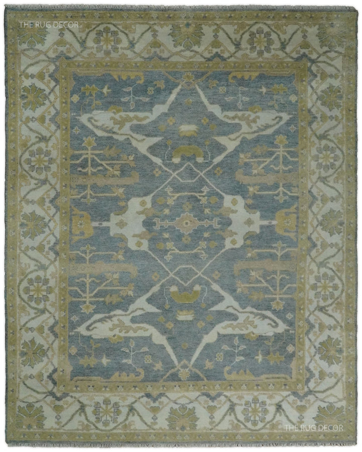 Gray and beige Oushak rug with a central floral medallion and ornate border