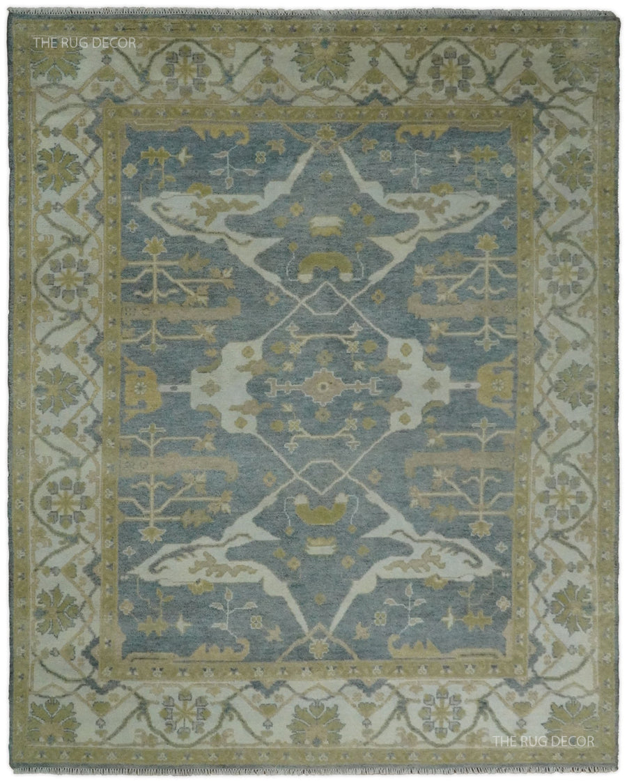 Gray and beige Oushak rug with a central floral medallion and ornate border