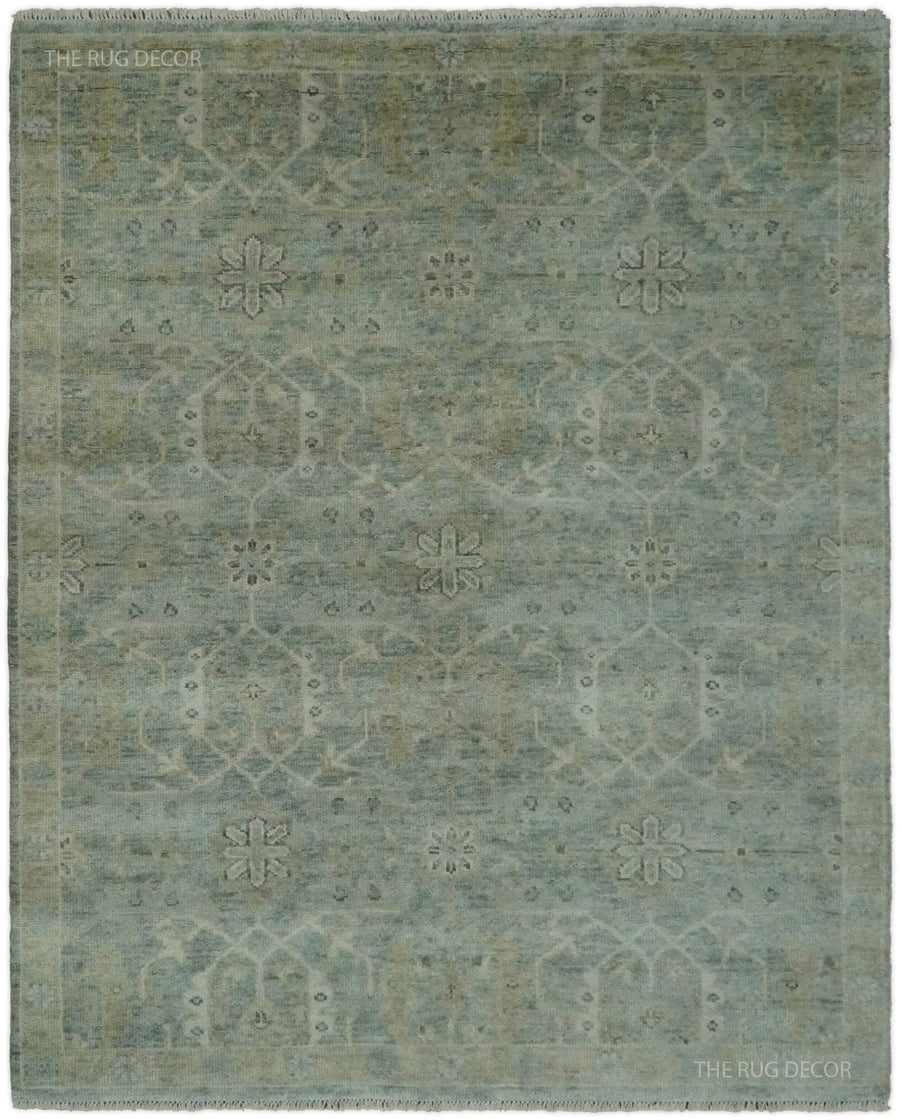 Blue and ivory hand-knotted wool rug with a traditional floral pattern and border