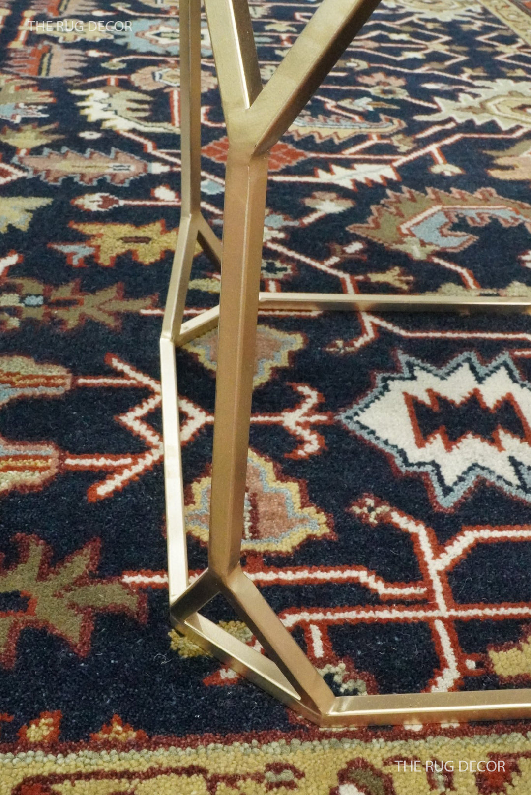 Close-up of the rug's dark blue wool pile and geometric motifs