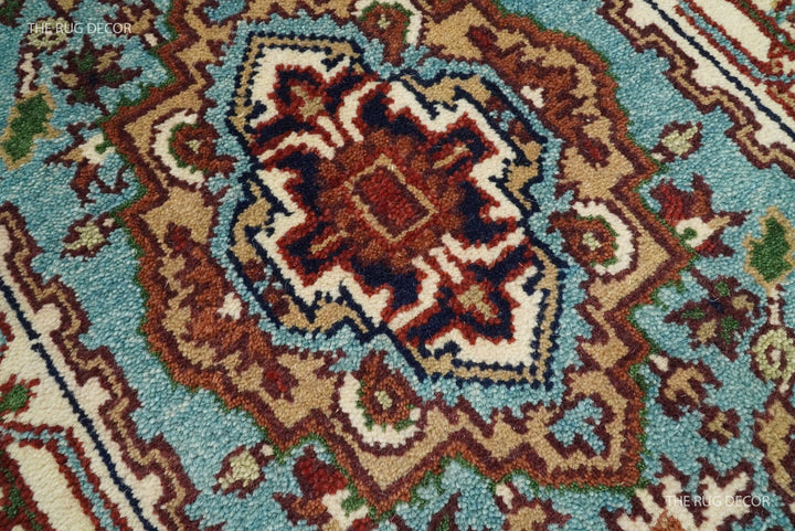 Close-up of the rug's blue field, floral medallion, and dense wool pile