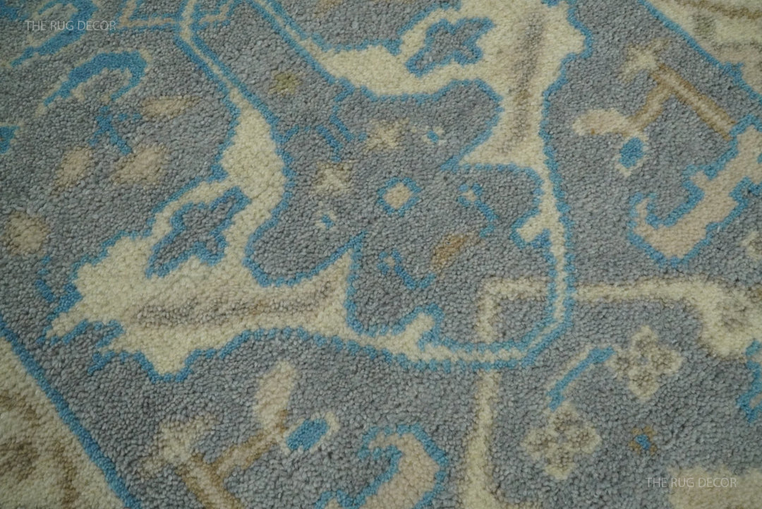 Close-up of the runner rug's textured gray wool pile and blue and beige floral pattern