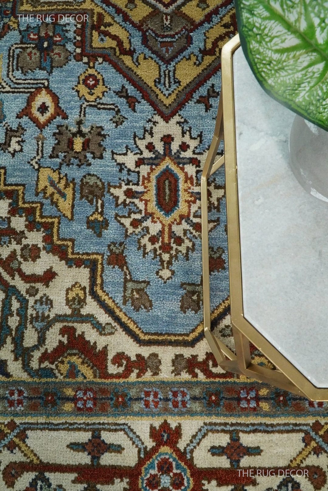 Sera wool rug detail showing blue and ivory floral motifs and patterned border