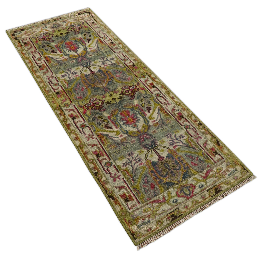 Angled view of the bordered floral runner rug with cream fringe