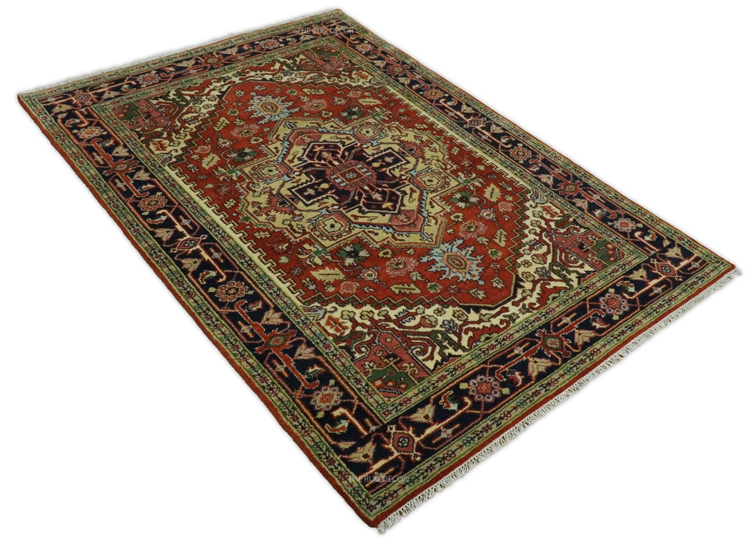 Corner view of traditional medallion rug in rust red, dark blue, and cream with patterned border