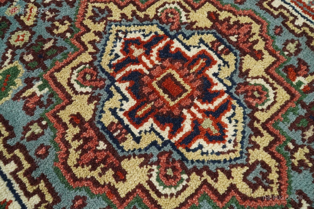 Wool runner rug detail showing a blue, ivory, and rust floral medallion