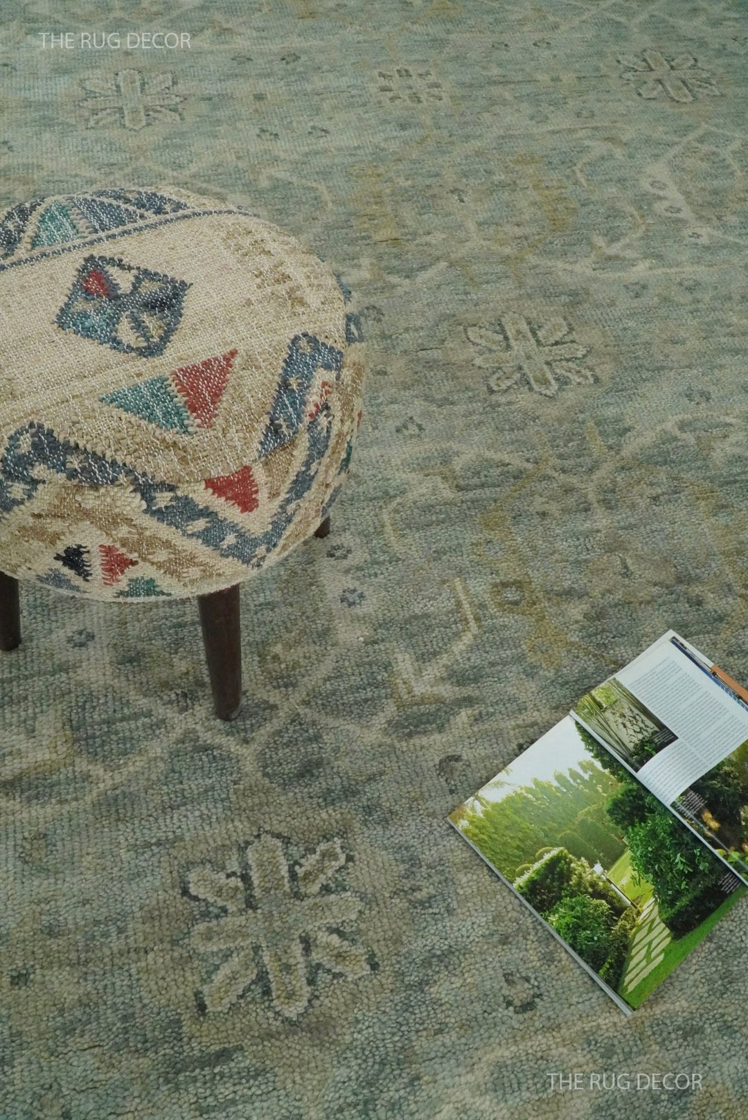 Blue and ivory rug with a faded floral motif and textured wool pile