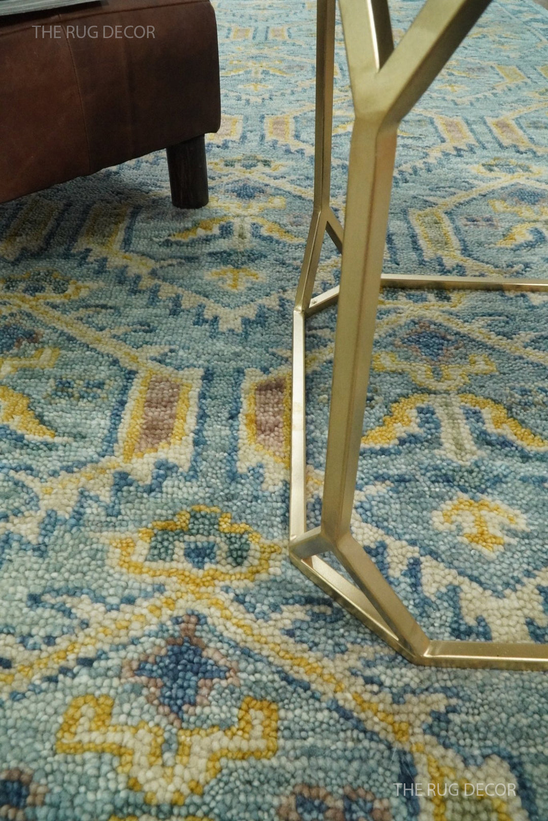 Close-up of the rug's thick wool pile and antique blue, mustard, and muted accent colors