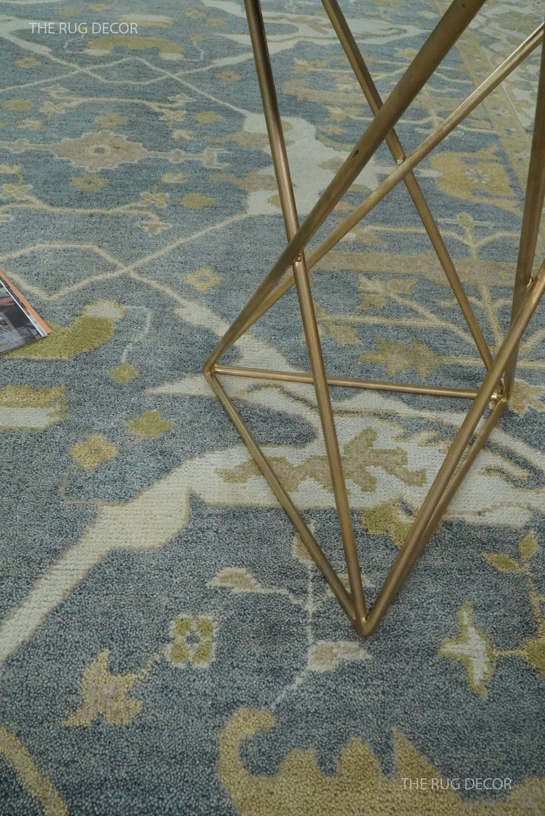 Close-up of the rug's gray field with beige and olive floral motifs