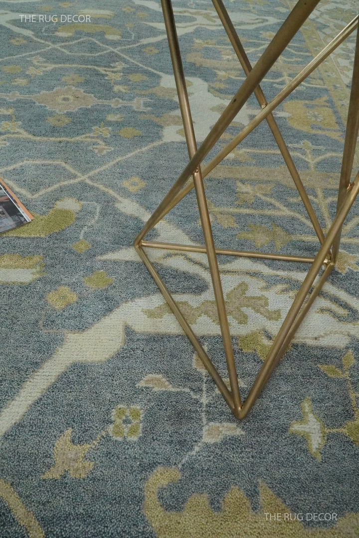 Close-up of the rug's gray field with beige and olive floral motifs
