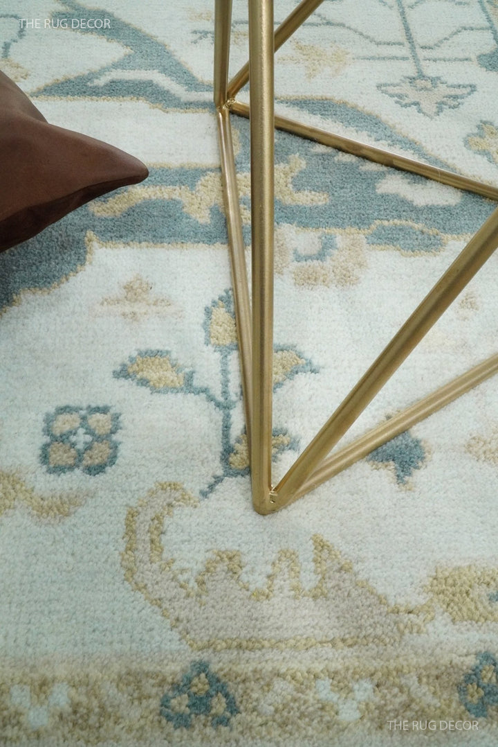 Teal and ivory Oushak wool rug close-up with geometric floral motifs