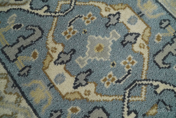 Wool runner rug close-up showing blue-gray pile and beige floral medallions