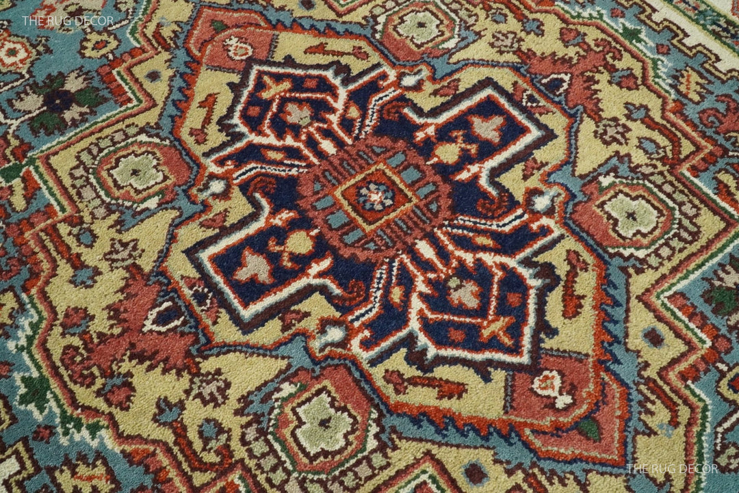 Close-up of the rug's blue, rust, and ivory central medallion and wool pile