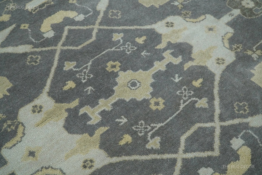 Close-up of vintage Oushak-style rug with gray field and light ivory accents