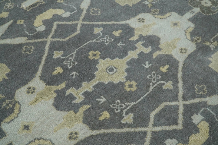 Close-up of vintage Oushak-style rug with gray field and light ivory accents