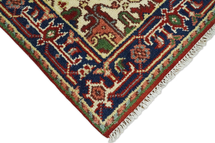 Rug corner detail showing ornate border, woven texture, and cream fringe