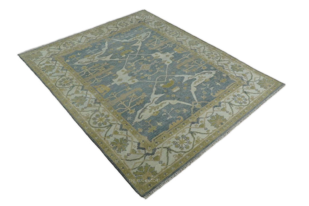 Full view of a rectangular gray and beige Oushak rug with an ornate border